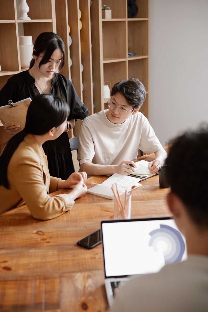 A small team reviewing notes together around a table